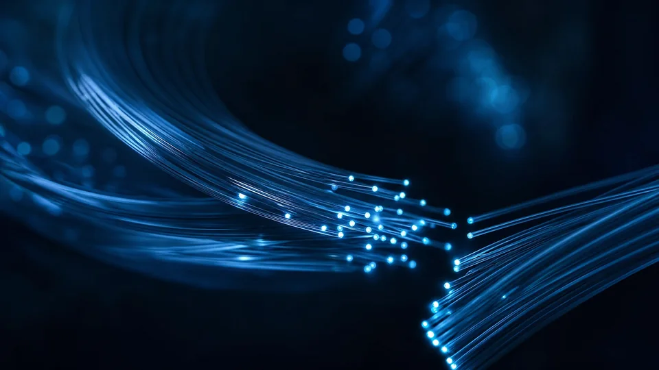 Illustrative fibre-optic strands with softly glowing cyan tips